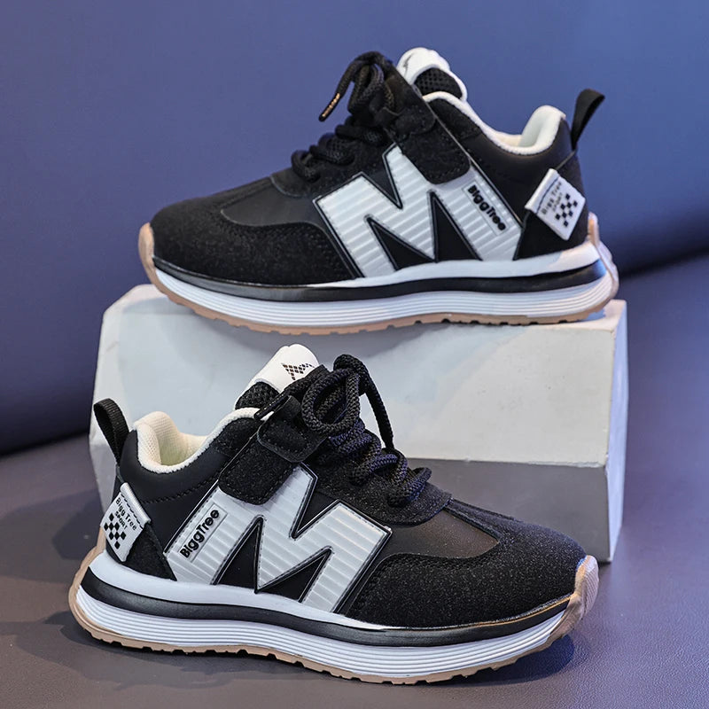 Black and white sneakers with a prominent 'M' logo on a blue background