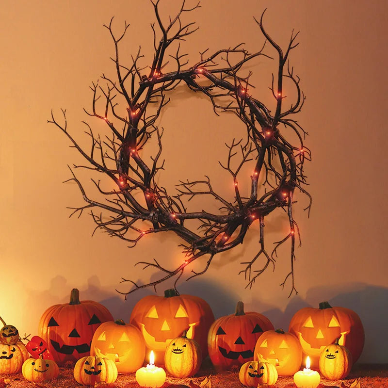 Black twig wreath on door with pumpkins