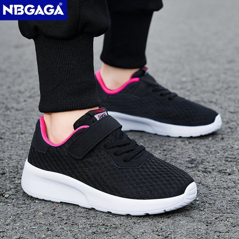 Black children's shoes with pink accents on a gray surface, featuring the brand 'NGBAGA'.