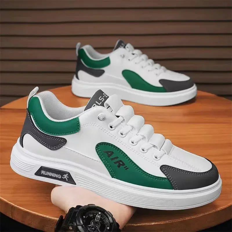 White sneakers with green and black accents on a wooden surface