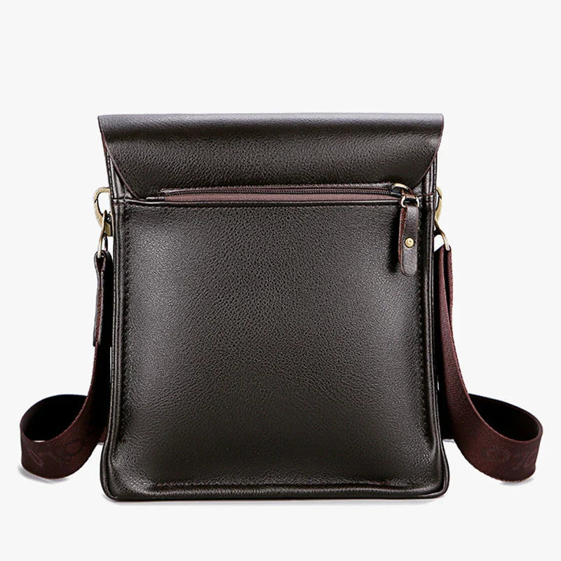 Black leather crossbody bag with brown strap on a white background