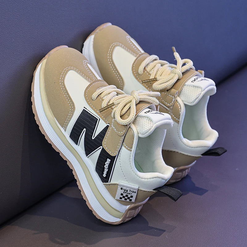 Beige and white sneakers with a brand logo on a purple surface