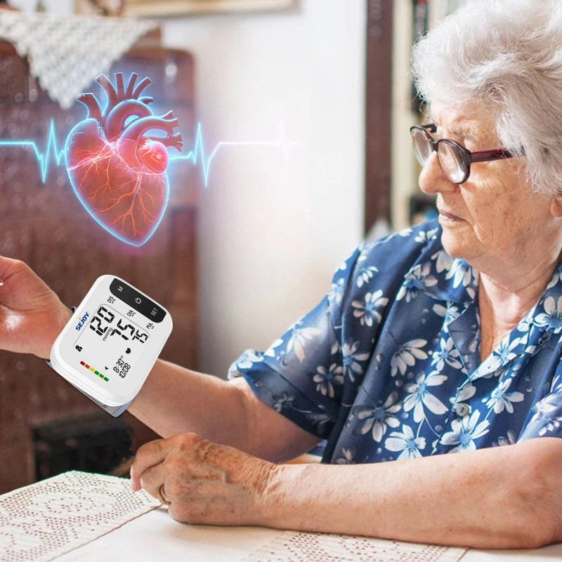 Woman using a blood pressure monitor with a heart graphic in the background