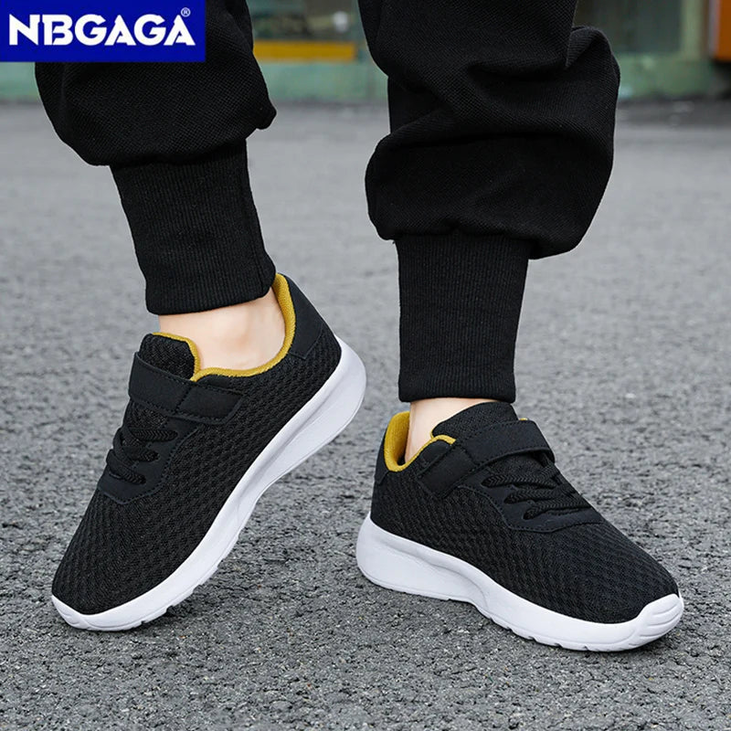 Black sneakers with white soles worn by a person on a gray pavement, with NBGAGA branding.