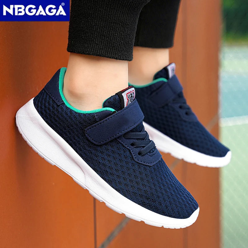 Navy blue sneakers with white soles worn by a person, against a blurred background.